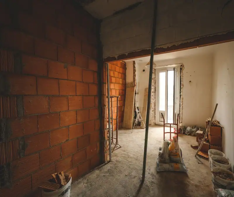 Example of a space before renovation: bare brick and rough plaster